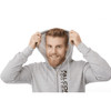 A man in a grey fleece zip hoody, smiling and pulling the hood over his head, with branding visible on the garment.
