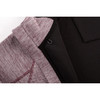 A close-up of a maroon and black zip hoodie featuring a textured fabric and an inner lining. It has a logo.