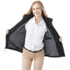 A woman wearing a black fleece lined jacket, smiling and showcasing the interior, with a collared white shirt underneath.