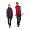 A woman in a navy vest and a man in a red vest, both paired with casual outfits, standing side by side.