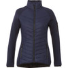 A women's insulated jacket in navy blue with a high collar and zippered pockets. It features a logo on the sleeve.