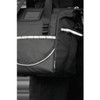 A black cooler bag features reflective detailing and multiple pockets, designed for carrying items securely. It has a logo.