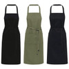 Three aprons in black, olive green, and dark grey with adjustable neck straps and waist ties. Each features a front pocket.