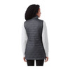 A woman wearing a dark grey lightweight packable insulated puffer vest, viewed from the back. The vest has a logo.