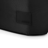 A close-up of a black tote bag featuring a branding logo on a textured surface.