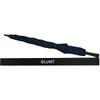 A navy umbrella with a twisted design, accompanied by a protective sleeve, featuring a logo.