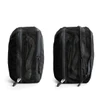 A black packing cube with mesh panels, featuring zip closures on both sides. It has a logo on one side.
