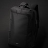 A black Swiss Peak convertible travel backpack with adjustable shoulder straps and a front compartment, featuring a logo.