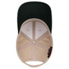 A low profile baseball cap in beige and dark green, featuring an inner lining and a logo.
