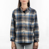 A plaid flannel shirt in shades of navy, cream, and light blue with long sleeves and a button-up front.
