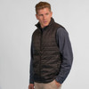 A quilted puffer vest in black, featuring a zip front and a simple design with a logo.