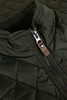 A quilted green vest featuring a zip closure and a leather accent on the zipper.
