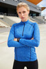A long-sleeved sports shirt in blue with a zip and fitted design, featuring a logo on the front.