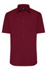 A short-sleeved, burgundy button-up shirt with a single chest pocket and a collar. It features a logo at the neck.