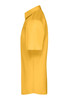 A short-sleeved, button-up shirt in mustard yellow, featuring a collar and a logo.