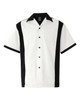 A short-sleeved, button-up shirt in white with black side panels and a chest pocket, featuring a logo.