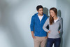 A blue men's hooded jacket and a grey women's hooded jacket, both featuring front pockets, against a light backdrop.