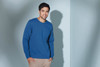 A blue sweatshirt featured on a male model against a light background, with a logo visible on the garment.