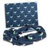 A navy infinity scarf featuring a patterned design with green and white elements, accompanied by a matching wrap.