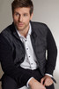 A men's hybrid sweat jacket, featuring a black body with a smooth finish and contrasting fabric on the sleeves.