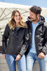 A black ladies' 3-in-1 jacket with a hood, displayed on a woman and a man outdoors. The woman is smiling.