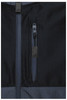 A close-up of a black Hardshell Workwear Jacket featuring multiple zippered pockets and textured fabric.