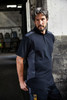 A men's workwear polo shirt in navy with grey panels, featuring a collar and logo.