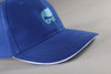 A blue cap with a curved brim and a logo on the front. Features contrast stitching along the brim.