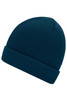 A knitted beanie in a deep teal colour with a ribbed texture and rolled cuff. It features a logo on the side.