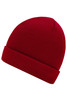 A red knitted beanie with a folded cuff and ribbed texture. It has a logo on the side.