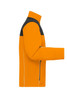 An orange and black softshell jacket featuring a zip pocket and a high collar. It has a logo on it.