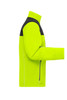 A bright yellow softshell jacket with a black upper section and a zippered pocket on the side. The jacket features a logo.