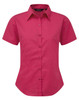 A short-sleeved button-up shirt in bright pink, featuring a classic collar and a fitted design. It has a logo on the side.