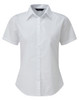 A white short-sleeved women's button-up blouse with a collar and a fitted design. It features a discreet logo.