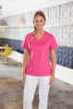 A pink ladies' stretch casack uniform tunic features a V-neck and pockets, displayed by a model in a modern setting.