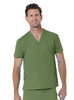 A unisex v-neck top in olive green with short sleeves and a chest pocket. The model is smiling.