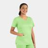 A woman wearing a bright green Matrix Women's Double V-Neck Top with short sleeves and a pocket.