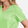 A women's green double V-neck top featuring short sleeves and a decorative detail on the shoulder.