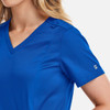 A women's double V-neck top in bright blue, featuring short sleeves and a small logo on the sleeve.