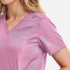A pink women's double V-neck top with a smooth fabric finish and a logo on the sleeve.