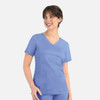 A women's mock wrap top in light blue, featuring short sleeves and two front pockets, with a subtle logo.
