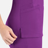 A purple mock wrap top featuring side pockets and a slit detail for added style. It includes a logo.