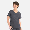 A women's curved mock wrap top in dark grey with short sleeves and two front pockets. Features a logo.