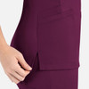A close-up of a women's curved mock wrap top in deep burgundy, featuring pockets and side slits.