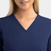A women's navy v-neck top featuring a contrast design, with a close-up view of the neckline and upper chest area.
