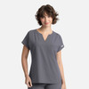 A grey women's dolman top featuring a V-neck and three pockets, with a small logo detail.