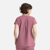 A women's top in a soft mauve colour with short sleeves and a pleat detail at the back. Features a logo.