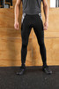 Men's black sports tights with a patterned panel on the sides, displayed on a person standing upright.
