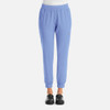 A pair of women's jogger pants in light blue with a comfortable waistband and a side pocket, featuring a logo.