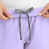A pair of women's joggers in lilac with a grey drawstring, featuring a logo on the waistband.